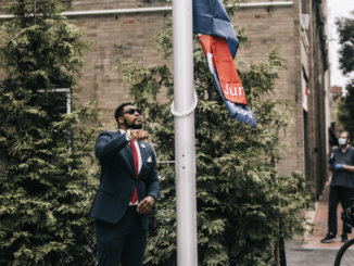 Malden CORE member Ted Louis Jacques raising the Juneteenth Flag at City Hall Plaza