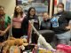 Volunteers in back of gift wrap and toys.
